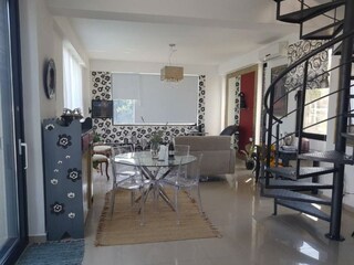 Living/dining area with patio door and spiral staircase