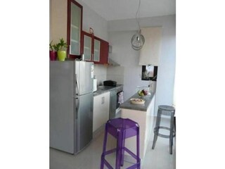 Open kitchen with stove, dishwasher and refrigerator