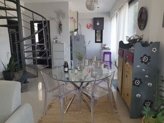 Helle Wohnküche mit Esstisch und Terrassenzugang.