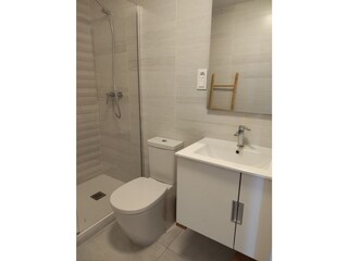 Two separate bathrooms with toilets and washbassin