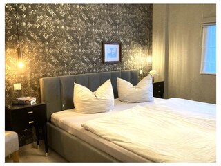 Das Schlafzimmer mit edlen Tapeten ...