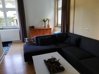 Zweites Wohnzimmer mit Sofa und Spielecke.
