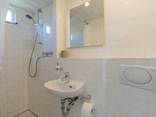 Badezimmer mit Dusche, Waschbecken und Toilette