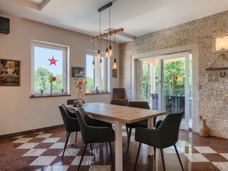 Bright dining area with garden views at Villa Ravina