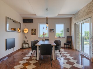 Bright dining room with garden access at Villa Ravina
