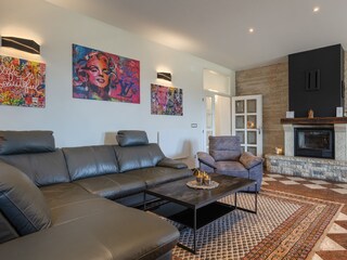 Spacious living room with fireplace and modern seating