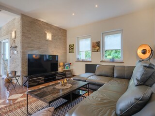 Comfortable living room with large sofa and TV