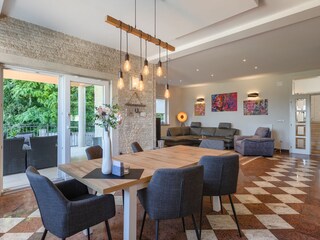 Bright dining area with garden views at Villa Ravina