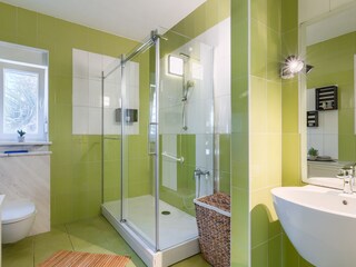 Bright bathroom with shower and contemporary fittings