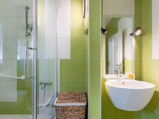 Modern bathroom with green tiles at Villa Ravina