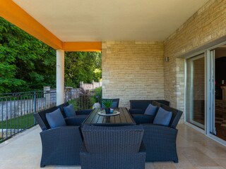Covered dining terrace with garden views