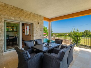 Covered dining terrace overlooking the pool&countryside