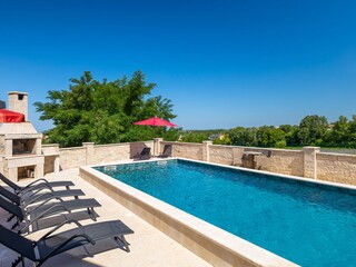 Private swimming pool with sun loungers &stone barbecue