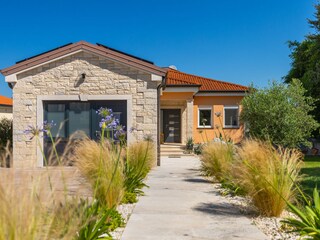 Welcoming entrance  with stone façade & lovely garden