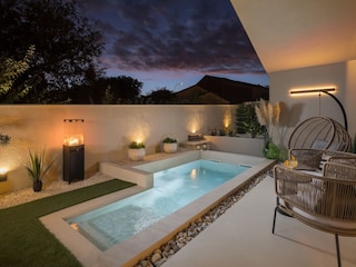 Outdoor pool at night in Villa Amoreta