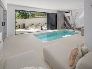 Lounge area with indoor pool and terrace access