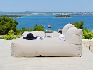 Comfortable sun loungers on the terrace of villa