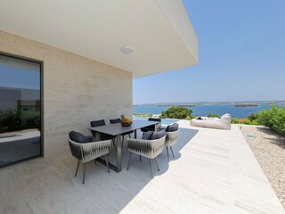 Outdoor dining area with sea view in Villa D3