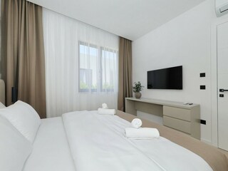 Bedroom with TV and window in villa