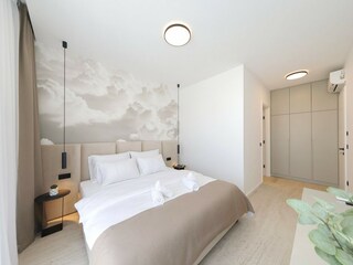 Comfortable bedroom with closet in villa