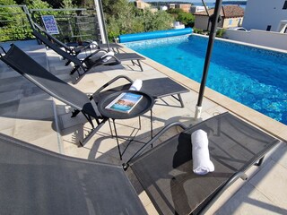 Sun loungers next to private pool of Villa Pura Vida