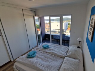 Bedroom with closet and sea view in villa