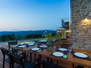 Outdoor dining area with view of villa