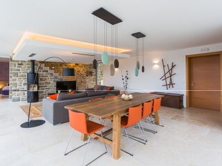 Dining table and livingroom with TV in villa