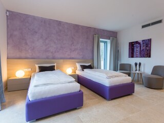 Two single beds in comfortable bedroom of villa