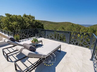 Sun deck with loungers overlooking the Adriatic