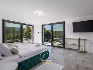 Open-space attic bedroom with freestanding bathtub