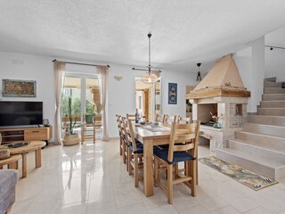 livingroom and dining area with TV and fireplace