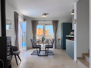 Fireplace and dining area with pool view