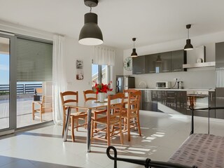 Dining area and fully equipped kitchen with balcony