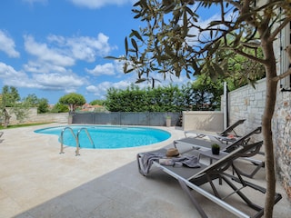 Private swimming pool with sun loungers and terrace