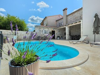 Sun loungers and parasol next to private Pool