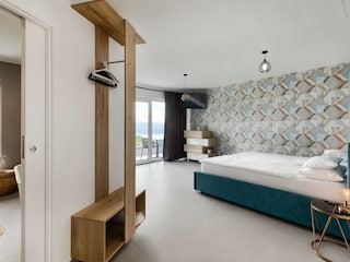 Bedroom with balcony, ensuite bathroom and sea view