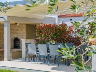 Covered outdoor dining area with BBQ