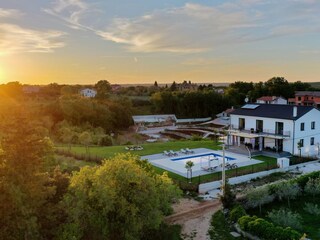Sunset over the forest next to modern villa