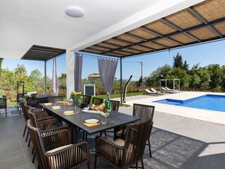 Outdoor dining area with pool view of villa
