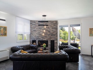 Modern livingroom with fireplace in villa near Medulin
