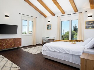 Comfortable bedroom with TV and view