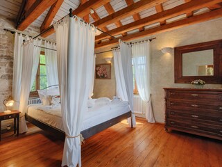 Master bedroom with four-poster bed in Villa Gelci