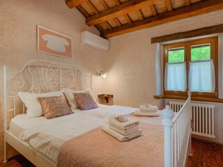 Romantic pastel bedroom with wrought-iron bed
