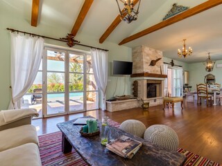 Living area with access to the pool terrace in villa