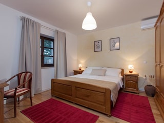 Bedroom with double bed and A/C in Villa Valade