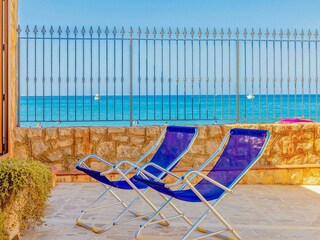 Deck chairs overlooking the turquoise sea