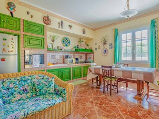 Open kitchen with dining area in sea green