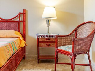 Stylish bedside table with rattan chair