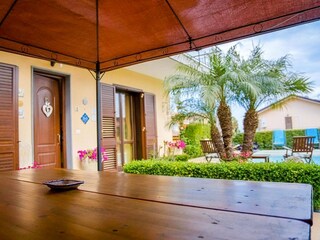 Covered terrace with pool view